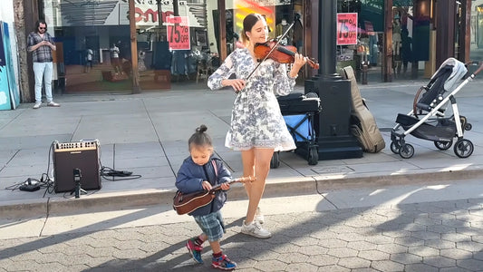 Violin prodigy plays Beatles classic and toddler steals the show