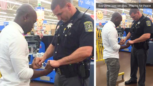 Man approaches police officer, they hold hands, then this happens